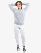 White fleece jogger pants from SpectraUSA, style P2005, shown on a model with an elastic waistband and relaxed fit.